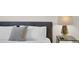 Close-up of bedside table with sleek, modern lamp in the bedroom at 4530 Narrative Ln, Kissimmee, FL 34746