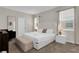 Bright bedroom featuring a plush bed, neutral decor, and a cushioned bench at 4530 Narrative Ln, Kissimmee, FL 34746