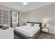 Bright bedroom with a queen bed, bedside tables and stylish decorations at 4530 Narrative Ln, Kissimmee, FL 34746