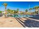 Large community pool with lounge chairs and palm trees, providing a resort-style experience for residents at 4530 Narrative Ln, Kissimmee, FL 34746