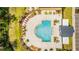 Overhead view of a community pool with chairs and tables that surround the pool and cabana at 4530 Narrative Ln, Kissimmee, FL 34746