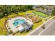 Aerial view of a community pool with a playset, picnic area, and sports field for recreation at 4530 Narrative Ln, Kissimmee, FL 34746