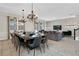 Dining room features an elegant chandelier and a large dining table for 12 at 4530 Narrative Ln, Kissimmee, FL 34746