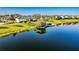 A picturesque pier extends over a lake with seating under a gazebo-style roof at 4530 Narrative Ln, Kissimmee, FL 34746