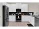 Modern kitchen with stainless steel appliances and sleek black backsplash at 4530 Narrative Ln, Kissimmee, FL 34746