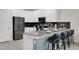 Kitchen featuring a breakfast bar with seating and stainless steel appliances at 4530 Narrative Ln, Kissimmee, FL 34746