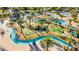 Aerial view of a winding lazy river and mini golf area with palm trees and tropical landscaping at 4530 Narrative Ln, Kissimmee, FL 34746