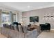 Inviting living room boasts modern lighting, comfortable seating, and sleek entertainment center at 4530 Narrative Ln, Kissimmee, FL 34746