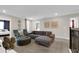 Cozy living room with a sectional sofa, ottoman, and stylish decor, perfect for relaxation and entertainment at 4530 Narrative Ln, Kissimmee, FL 34746