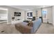 Open-concept living area featuring stylish furniture, decor, and a view into an adjacent bedroom at 4530 Narrative Ln, Kissimmee, FL 34746