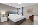 Comfortable bedroom featuring a king-size bed, upholstered headboard, and neutral tones for relaxation at 4530 Narrative Ln, Kissimmee, FL 34746