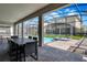 Outdoor patio area features a dining table and chairs overlooking a private pool at 4530 Narrative Ln, Kissimmee, FL 34746
