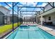 Inviting screened-in pool and spa area with ample lounging space under sunny skies at 4530 Narrative Ln, Kissimmee, FL 34746
