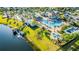 Aerial view of pool and splash pad next to waterway with dock and boat rentals at 4530 Narrative Ln, Kissimmee, FL 34746