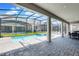 Screened-in outdoor pool and spa area with brick patio and comfortable lounge furniture at 4530 Narrative Ln, Kissimmee, FL 34746
