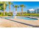 Community pool with palm trees and clear blue water for relaxing on hot days at 4530 Narrative Ln, Kissimmee, FL 34746