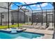 Inviting pool and spa surrounded by comfortable lounge chairs in a screened enclosure at 4530 Narrative Ln, Kissimmee, FL 34746