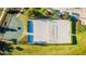 Overhead view of a sand volleyball court and basketball court surrounded by trees and landscaping at 4530 Narrative Ln, Kissimmee, FL 34746
