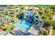 Aerial view of a waterpark area with slides, a pool, and a lazy river with miniature golf course at 4530 Narrative Ln, Kissimmee, FL 34746
