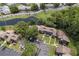 An aerial view of a multifamily property with lush landscaping and a pond nearby at 5083 Eaglesmere Dr # A12, Orlando, FL 32819