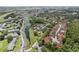Sprawling aerial view of a residential community with mature trees, a lake, and easy highway access at 5083 Eaglesmere Dr # A12, Orlando, FL 32819