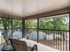 Outdoor balcony featuring tile floors, seating area, and views of the surrounding lake at 5083 Eaglesmere Dr # A12, Orlando, FL 32819