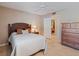 Comfortable bedroom featuring neutral walls, tile flooring, closet, and a dresser at 5083 Eaglesmere Dr # A12, Orlando, FL 32819