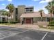 Exterior view of the building complex showcasing well-maintained landscaping, parking area, and modern architecture at 5083 Eaglesmere Dr # A12, Orlando, FL 32819