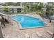 Community pool showcasing surrounding lounge furniture and a nearby lake at 5083 Eaglesmere Dr # A12, Orlando, FL 32819
