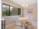 Eat-in dining area featuring a modern chandelier, a large window for natural light, and views of the neighborhood at 5083 Eaglesmere Dr # A12, Orlando, FL 32819