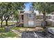 Inviting condo exterior with lush trees, private entrance, and convenient parking spaces at 5083 Eaglesmere Dr # A12, Orlando, FL 32819