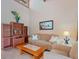 Cozy living room with vaulted ceilings, tile floors, and a comfortable seating arrangement at 5083 Eaglesmere Dr # A12, Orlando, FL 32819