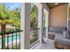 Relaxing balcony overlooking a sparkling pool and lush tropical landscaping, perfect for outdoor lounging at 524 Lanark Ct, Orlando, FL 32806