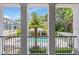 Scenic view from the balcony, showcasing the community pool, lounging area, and vibrant tropical foliage at 524 Lanark Ct, Orlando, FL 32806