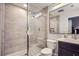 Bathroom featuring a glass enclosed shower, modern fixtures, and stone style tile at 524 Lanark Ct, Orlando, FL 32806