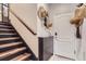 This entryway has a storage cabinet, with access to the staircase to the main level at 524 Lanark Ct, Orlando, FL 32806