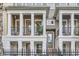 Attractive townhome facade featuring a covered balcony with black railings, a cozy seating area, and a welcoming entrance at 524 Lanark Ct, Orlando, FL 32806