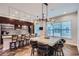 A spacious kitchen with a large island, modern lighting, herringbone floors and updated stainless steel appliances at 524 Lanark Ct, Orlando, FL 32806