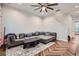 Cozy living room with herringbone floors, a large sectional sofa, and a modern ceiling fan at 524 Lanark Ct, Orlando, FL 32806