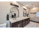 Elegant main bathroom with dual sinks, a walk-in shower, and modern fixtures at 524 Lanark Ct, Orlando, FL 32806