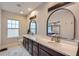 Luxurious main bathroom with dual sinks, a large mirror, a window, and generous counter space at 524 Lanark Ct, Orlando, FL 32806