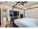 Spacious main bedroom with modern furnishings, including a four-poster bed, a TV, and ample storage at 524 Lanark Ct, Orlando, FL 32806