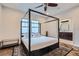 Comfortable bedroom featuring a four-poster bed, a ceiling fan, and an ensuite bathroom at 524 Lanark Ct, Orlando, FL 32806