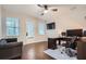 Office featuring a desk setup, hardwood floors, natural light from two windows, and a ceiling fan at 524 Lanark Ct, Orlando, FL 32806