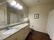 Bathroom featuring dual sinks, granite countertop and walk-in shower and tub at 5370 Diplomat Ct # 107, Kissimmee, FL 34746