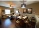 Open-concept living area with dining, comfy sofas, dark wood floors and natural light at 5370 Diplomat Ct # 107, Kissimmee, FL 34746