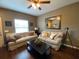 Relaxing living room featuring cozy sofas, ceiling fan, and unique decor at 5370 Diplomat Ct # 107, Kissimmee, FL 34746
