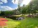 Picturesque pond surrounded by mature trees and landscaping, creating a serene natural environment at 5370 Diplomat Ct # 107, Kissimmee, FL 34746