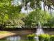 Scenic pond with a fountain, lush greenery, and a tranquil atmosphere perfect for relaxation at 5370 Diplomat Ct # 107, Kissimmee, FL 34746