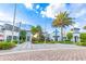 Beautiful clubhouse exterior with manicured landscaping, palm trees and inviting entrances for businesses and recreation at 665 Longboat Dr, Davenport, FL 33896
